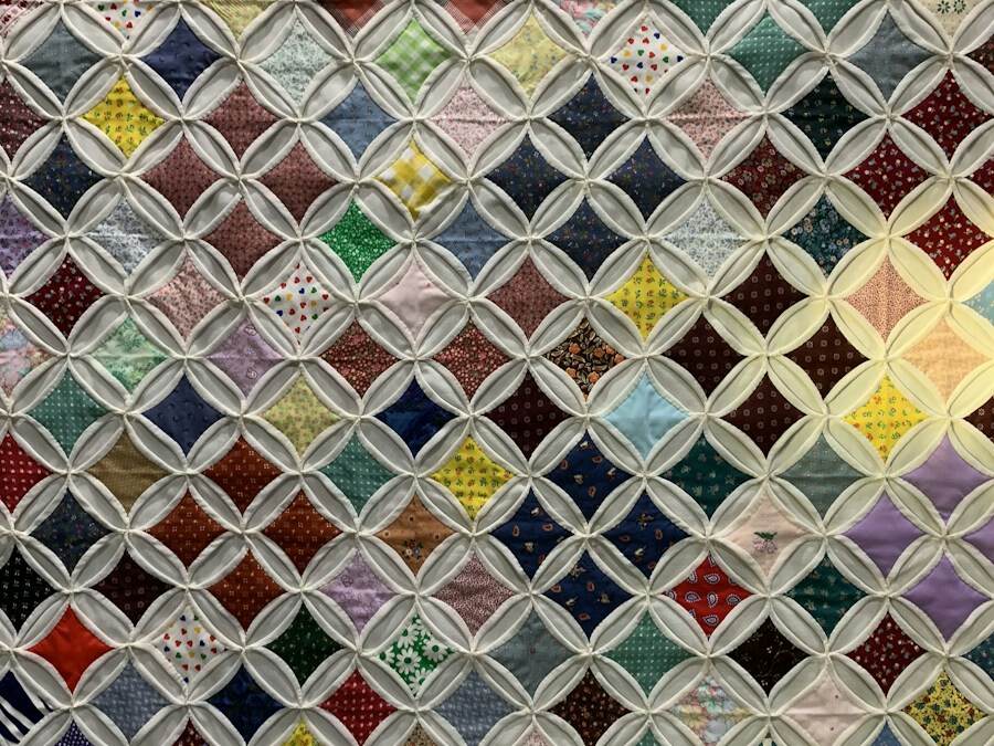 A quilt made of many small colorful blocks